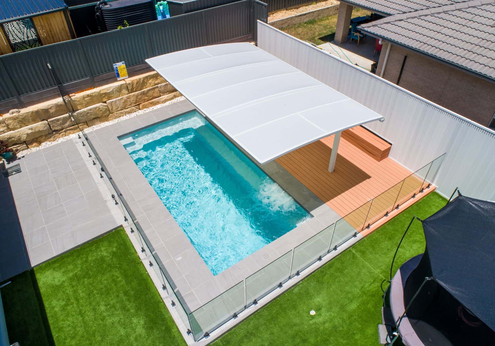 Fibreglass pool installation in a Macarthur region backyard by Aqualuxe Projects